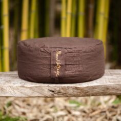 Organic meditation cushion with embroidered Breath and Smile calligraphy, supporting sitting meditation with comfort and stability