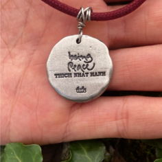 Plum Village pendant of the ‘Being Peace’ Seals collection engraved in the back